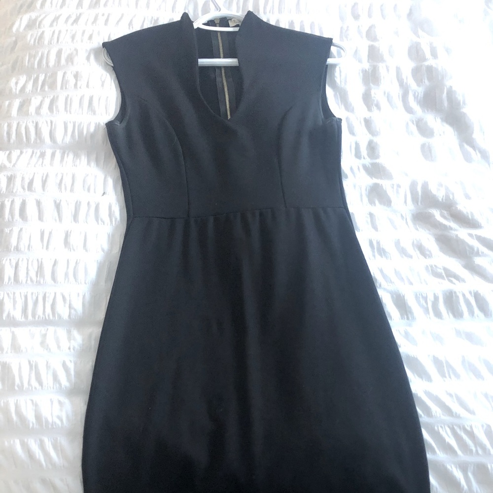 Black dress with gold zipper detail.